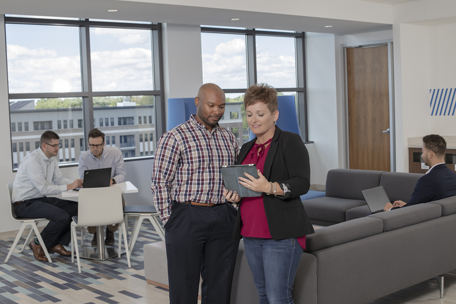 Allied employees stand, discussing available products and services