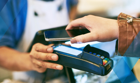 hand with phone using cardless payment system